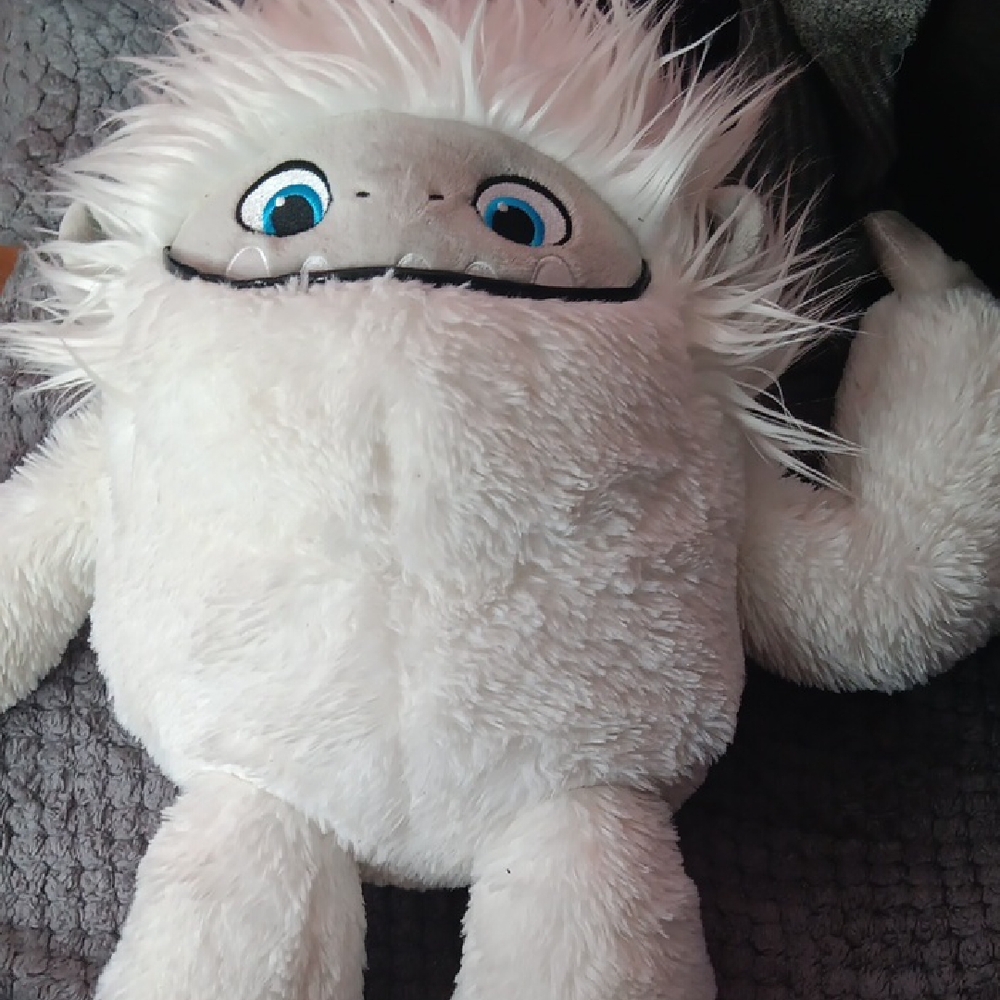 White Stuffed Animal with Fluffy Fur and Blue Eyes